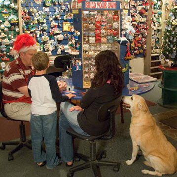 Samantha helping a family build an ornament